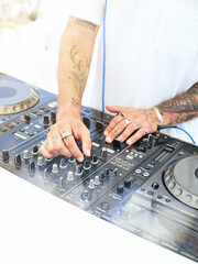 Crop DJ playing music on console