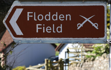 A sign pointing the way to the famous battle site of Flodden Field in Branxton, Northumberland, England, UK.