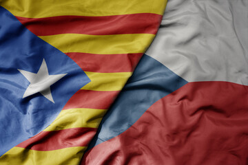 big waving national colorful flag of catalonia and national flag of czech republic .