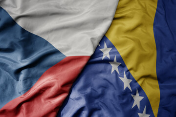 big waving national colorful flag of czech republic and national flag of bosnia and herzegovina .