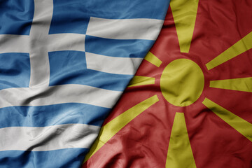 big waving national colorful flag of greece and national flag of macedonia .