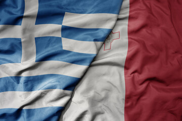 big waving national colorful flag of greece and national flag of malta .