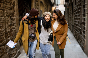 Cheerful multi-ethinc group of friends tourists having fun and walking on the streets of Barcelona - Travel, holidays and friendship concept © carlesiturbe