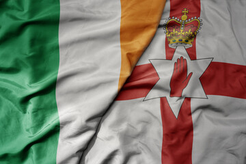 Obraz premium big waving national colorful flag of ireland and national flag of northern ireland .
