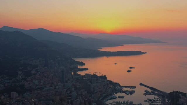 Aerial panoramic view of Monaco Monte Carlo City and Port Hercule French Riviera Coastline when sun is rising on the sky