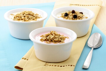 Delightful Breakfast Spread of Yogurt Bowls with Granola and Hot Chocolate on Blue Napkin: A Harmonious Start to the Day