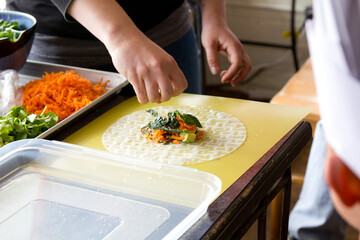 Bustling Kitchen Scene with Close-Knit Group Engrossed in Culinary Artistry: A Symphony of Flavors...