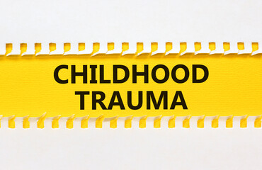 Childhood trauma symbol. Concept words Childhood trauma on beautiful yellow paper. Beautiful white...