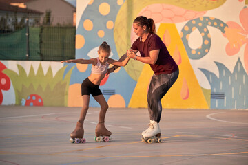 Concentrate child practicing new element of roller skating with