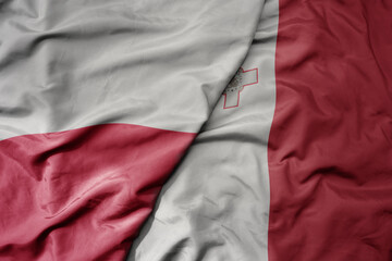 big waving national colorful flag of poland and national flag of malta .