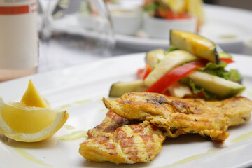 Grilled chicken with grilled vegetables served on the restaurant table