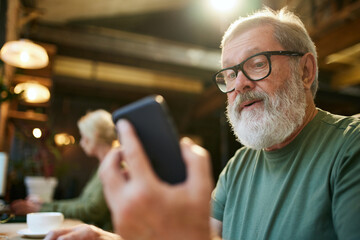 Senior business people, men and women working in office, using gadgets. Man chatting on mobile phone. Communication. Concept of business, age diversity, education, modernity, innovations, assistance