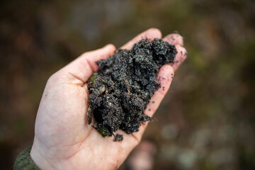  farmer holding soil looking at soil carbon in the america