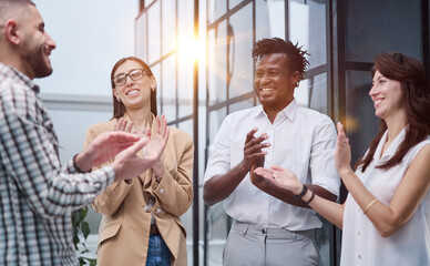 Laughing multiethnic business people talking in the office.