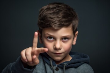 Medium shot portrait photography of a tender boy in his 30s making a gesture of i'm thinking with the finger on the head against a metallic silver background. With generative AI technology