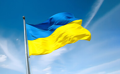 Blue and yellow colors Ukrainian national flag against blue sky. Ukraine is country in Eastern Europe.