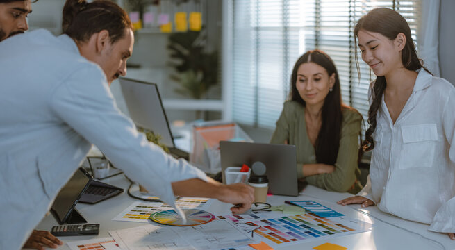 Startup team collaborates on color selection for user centric product design, optimizing experience