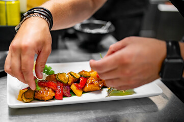 chef cooking chicken sweet and sour sauce on kitchen