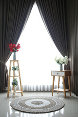 interior decoration of nightstands and flower shelves near the window