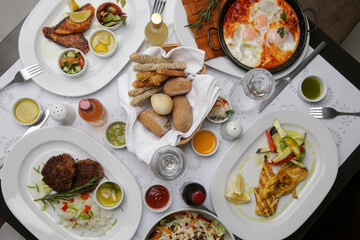 Various Mediterranean dishes and wines served on the restaurant table