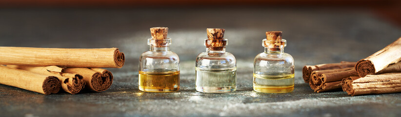 Horizontal header with essential oil bottles with true cinnamon sticks
