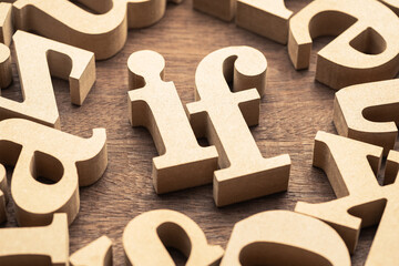 Closeup the IF word in the group of wooden English alphabets, learning conjunction in English...