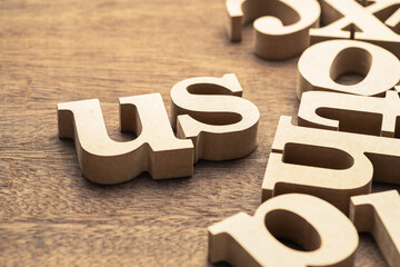 Closeup the US word in the group of wooden English alphabets , About Us concept