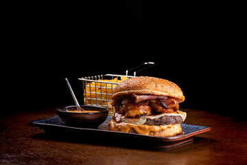 burger surf and turf com burger with melted beef cheddar shrimp with cheddar sauce black background