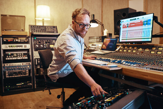 Music producer working with equipment in his recording studio