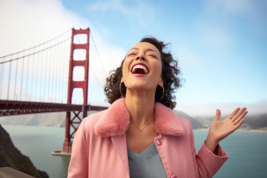 Medium shot portrait photography of a happy girl in her 30s blowing kisses wearing a chic cardigan at the golden gate bridge in san francisco usa. With generative AI technology