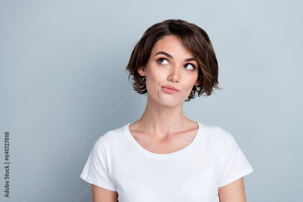 Sticker photo of suspicious thoughtful lady wear white t-shirt looking empty space isolated grey color backg