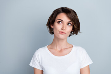 Photo of suspicious thoughtful lady wear white t-shirt looking empty space isolated grey color background