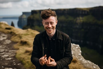 Close-up portrait photography of a happy boy in his 30s dusting off hands donning a delicate lace choker at the cliffs of moher in county clare ireland. With generative AI technology