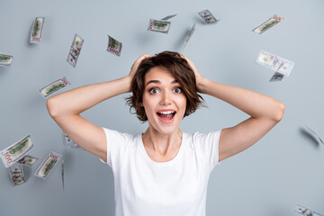 Photo of impressed funky lady wear white t-shirt arms hands head become millionaire isolated grey color background