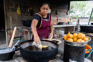 Latin woman preparing food in a rural kitchen