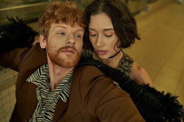 portrait of young stylish interracial couple posing together in public laundry