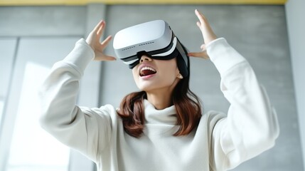 Naklejka premium Young woman sitting at desk and wearing a VR headset, Experiencing virtual reality, Interacting with virtual reality.