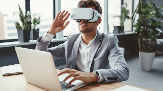 Businessman in VR headset with laptop sitting in office, Virtual reality.