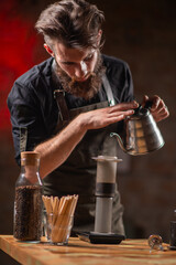 Fototapeta na wymiar Talented barista using the Aeropress coffee maker to create a rich and flavorful cup of coffee