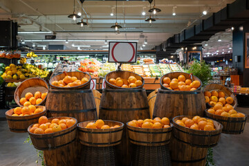 Fresh orange placing in wood barrel display in grocery store. Fresh orange arrange neatly in super market.