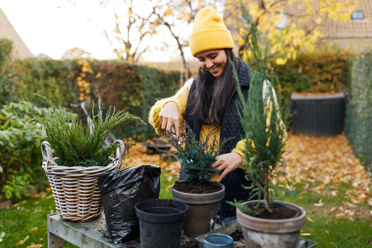 Smiling woman gardening in the autumn
