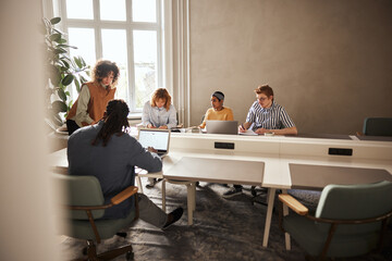 Manager meeting with her diverse team