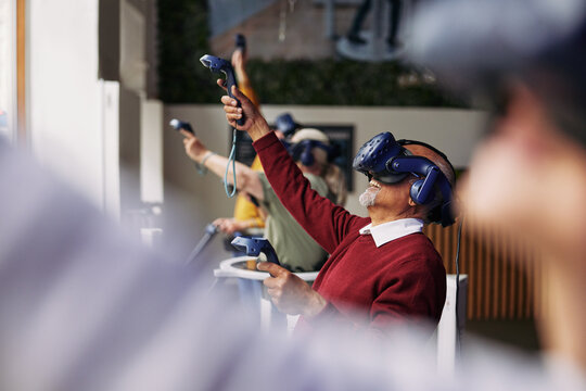 Senior man and friends visiting a vr club