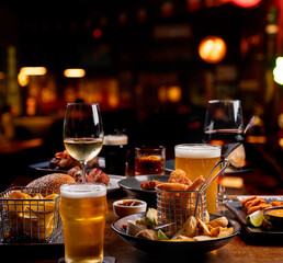 dinner banquet with prawns finger food portions on a table set with starters beers wines drinks