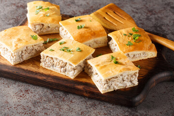 Italian sausage gratin with cream cheese with crescent crust close-up on a board on the table. horizontal