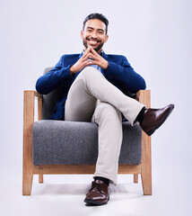 Portrait, confident and business man on chair in studio isolated on a white background....