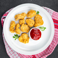 chicken nuggets tomato sauce deep-fried meat ready to eat healthy meal food snack on the table copy space food background rustic top view