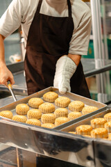 Mooncake making process. A mooncake  is a Chinese bakery product traditionally eaten during the Mid-Autumn Festival.