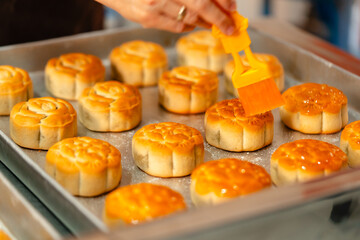 Mooncake making process. A mooncake  is a Chinese bakery product traditionally eaten during the Mid-Autumn Festival.