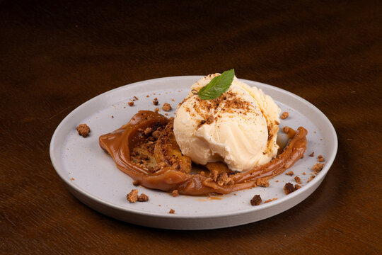banoffee dessert with banana dulce de leche vanilla ice cream and ground biscuit angle view